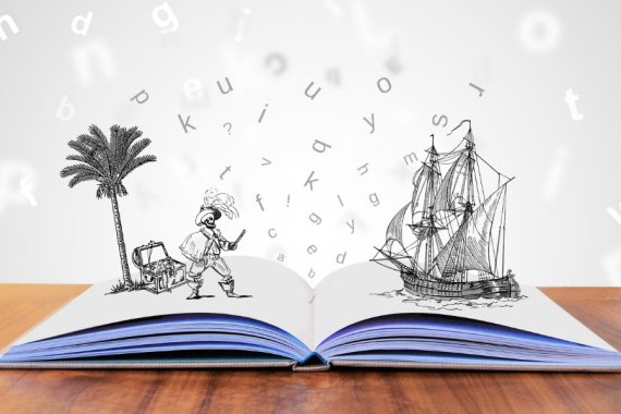 libro aperto su tavolo con immagine di pirati e vascello